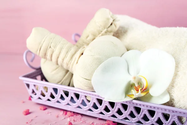 Still life with beautiful blooming orchid flower, spa treatment on tray, on color wooden background — Stock Photo, Image