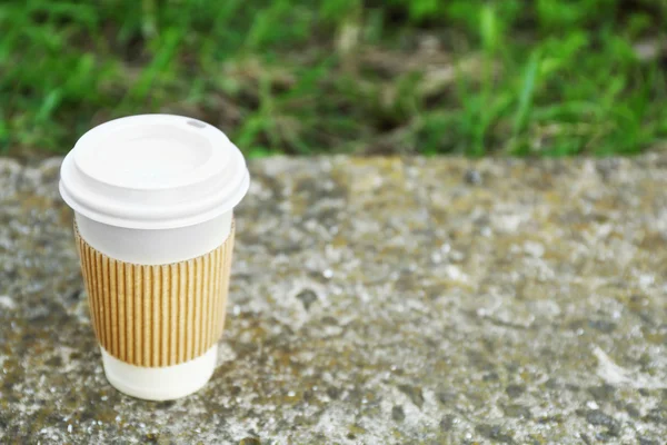 Paper cup on gray stone, outdoors — Stock Photo, Image
