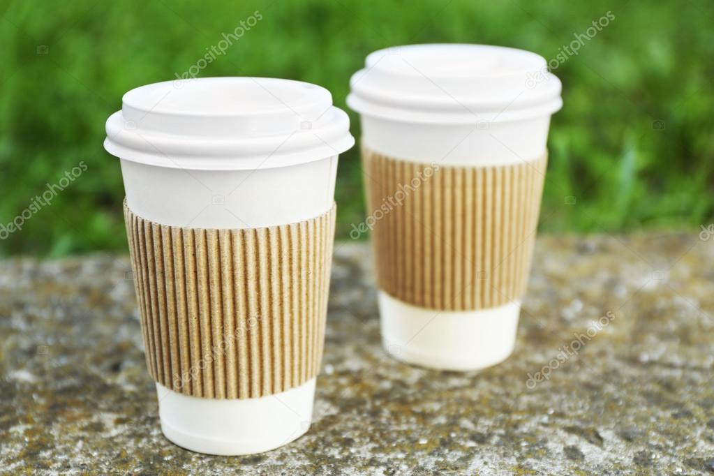 Paper cups on gray stone, outdoors