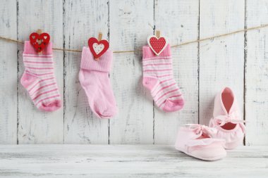Cute toddler shoes on wooden background