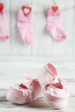 Cute toddler shoes on wooden background