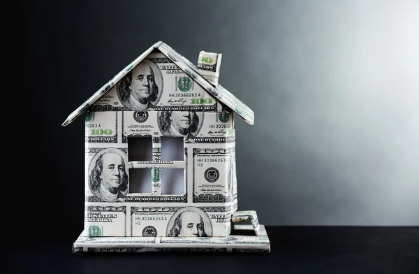 Money house on table on gray background — Stock Photo, Image