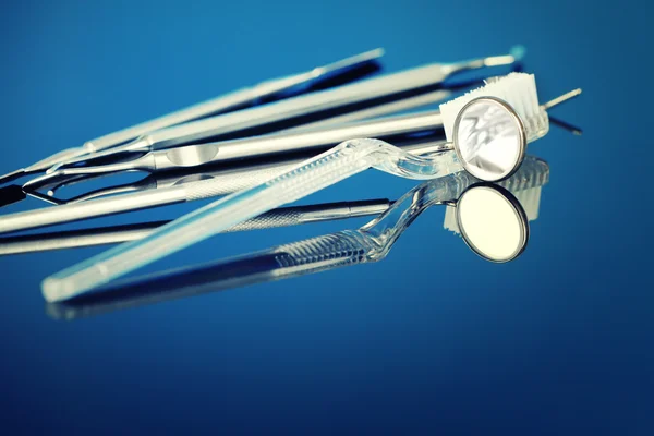 Dentist tools with brush on blue background — Stock Photo, Image