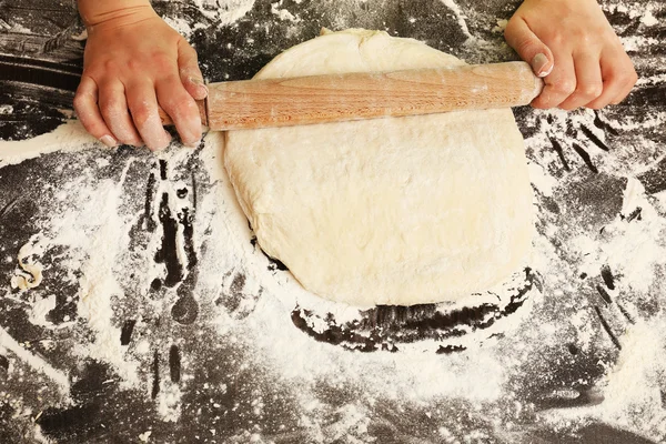 Making dough by female hands on wooden table background — Stock Photo, Image