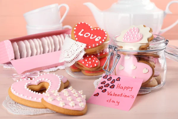 Heart shaped cookies for valentines day and tea bags on wooden background — Stock Photo, Image