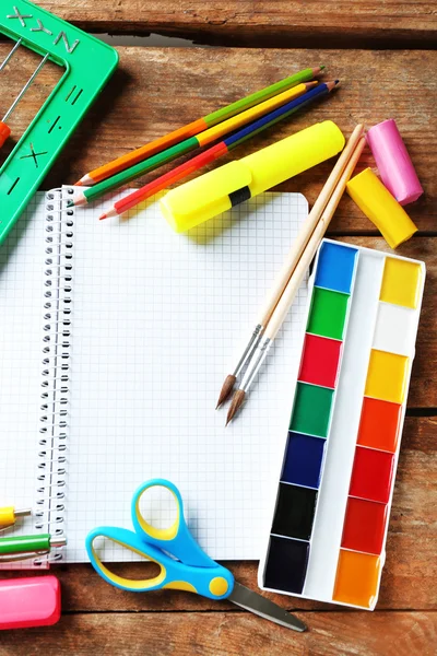 Notebook and bright school stationery on old wooden table — Stock Photo, Image