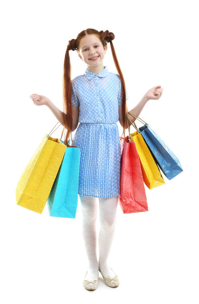 Beautiful little girl with shopping bags, isolated on white