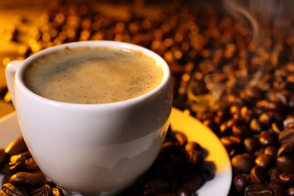 Cup of coffee with grains, closeup — Stock Photo, Image