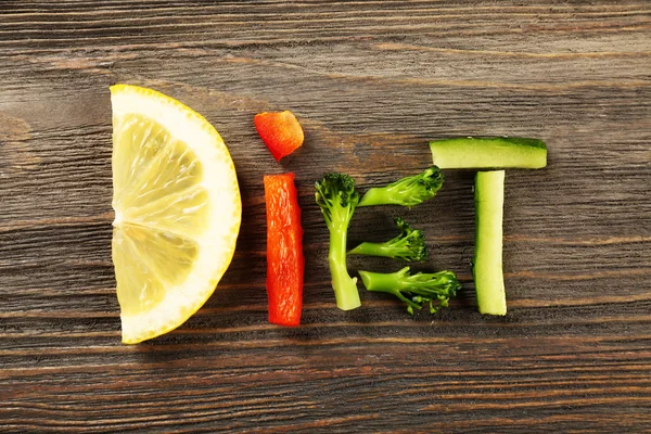 Word DIET made of sliced vegetables on wooden background — Stock Photo, Image