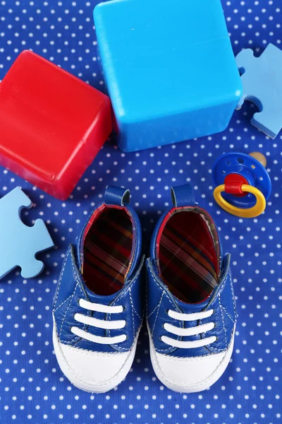 Baby shoes on blue cloth background — Stock Photo, Image