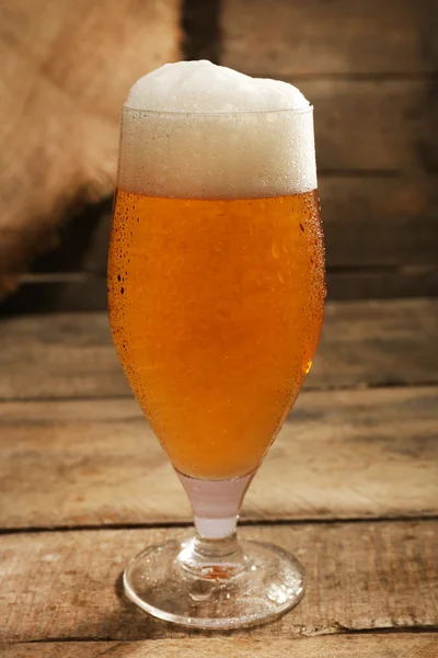 Glass of beer on wooden background — Stock Photo, Image