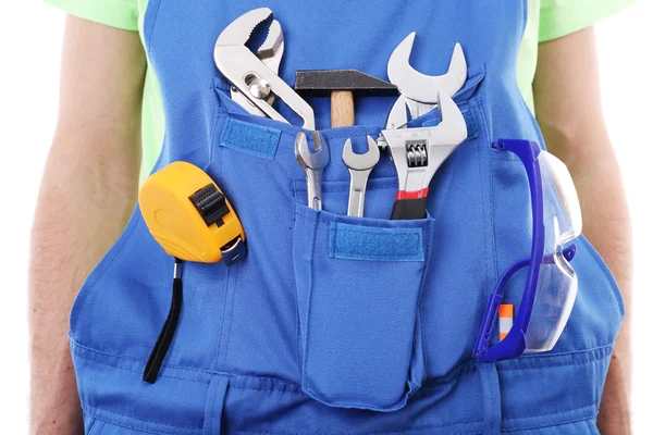 Man in overall met tools — Stockfoto