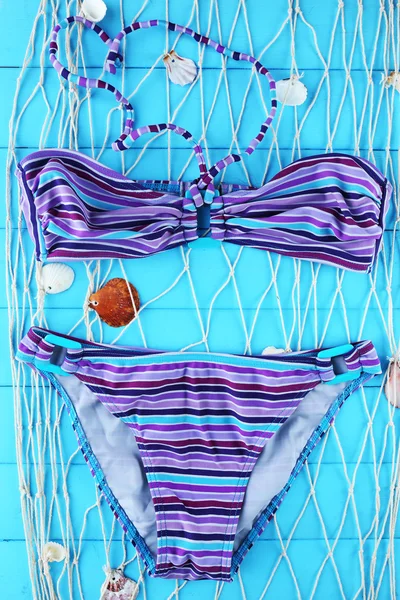 Sea still life with swimsuit on wooden table, top view — Stock Photo, Image