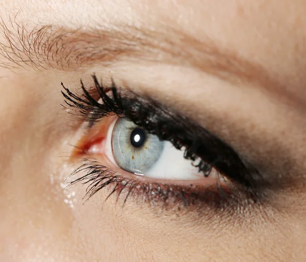 Eye of young woman with tear drop close up — Stock Photo, Image