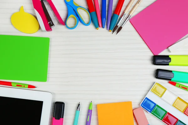 Digital tablet with stationery on wooden background — Stock Photo, Image