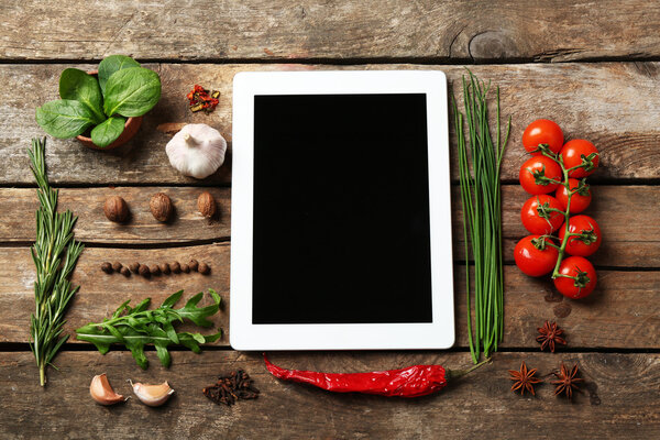Digital tablet with fresh herbs