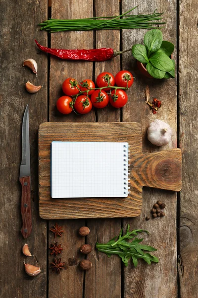 Open recipe book with fresh herbs — Stock Photo, Image