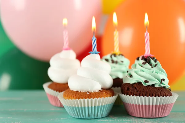 Deliciosos cupcakes de cumpleaños en la mesa sobre un fondo brillante —  Fotos de Stock