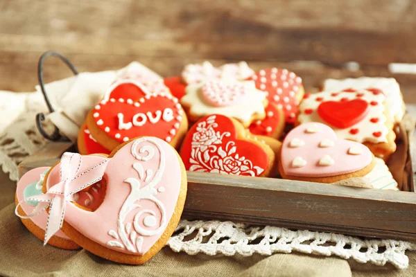 Heart shaped cookies for valentines day on tray, on wooden background — Stock Photo, Image