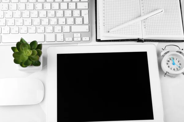 Office workplace with tablet and pot plant close up — Stock Photo, Image