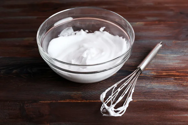 Whipped egg whites for cream on wooden background — Stock Photo, Image