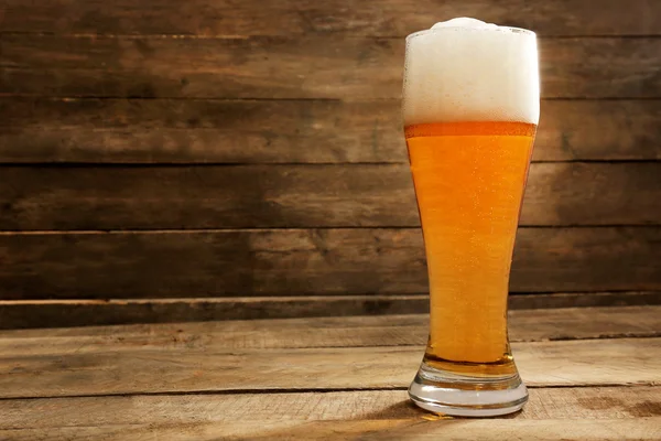 Glass of beer on wooden background — Stock Photo, Image