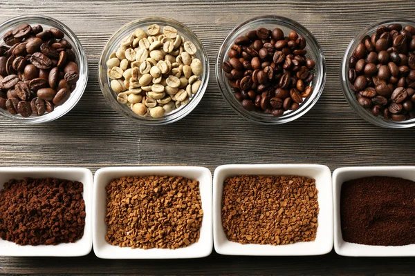 Coffee beans in saucers on wooden background — Stock Photo, Image