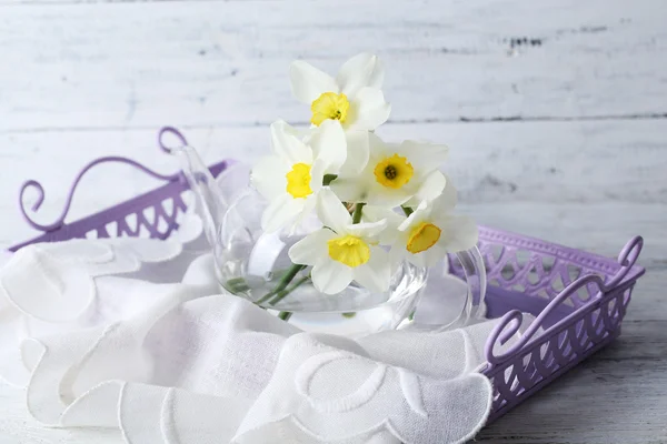 Fresh narcissus flowers in tray on wooden background — Stock Photo, Image