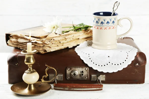 Old wooden suitcase with old books and flowers on wooden background — Stock Photo, Image