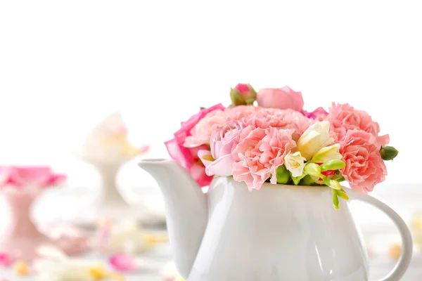 Beautiful spring flowers in teapot isolated on white — Stock Photo, Image