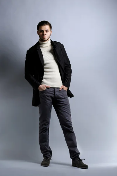 Elegant man on gray background — Stock Photo, Image