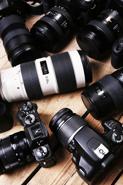 Moderna kameror på träbord, närbild — Stockfoto