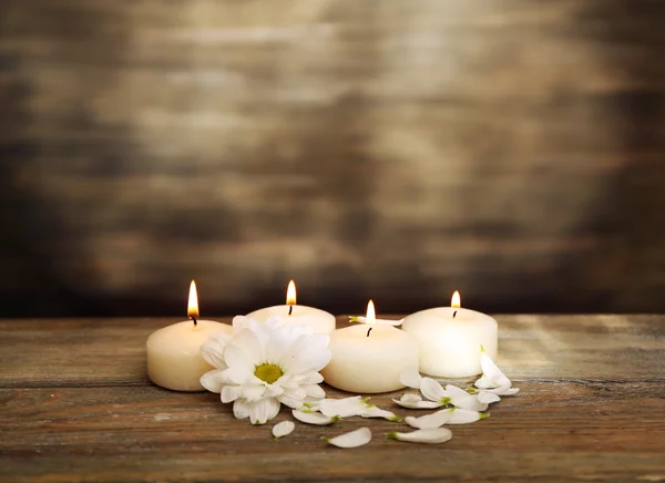 Candles with chrysanthemum on wooden background — Stock Photo, Image