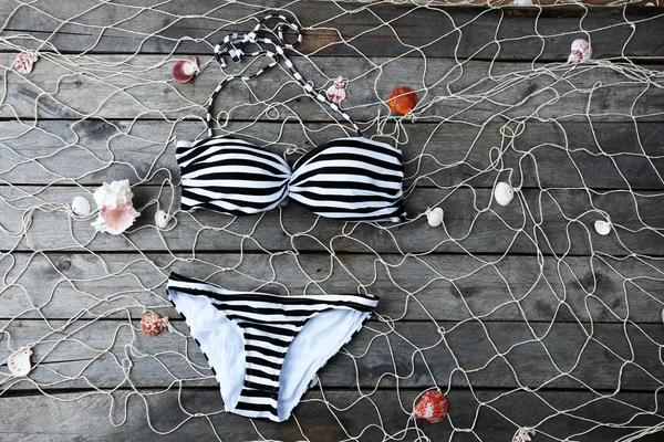 Swimsuit on wooden background — Stock Photo, Image