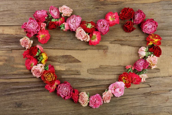 Heart of beautiful dry flowers on wooden background — Stock Photo, Image