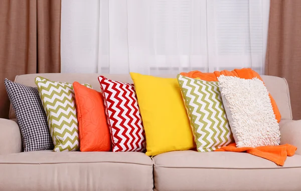 Sofa with colorful pillows in room — Stock Photo, Image