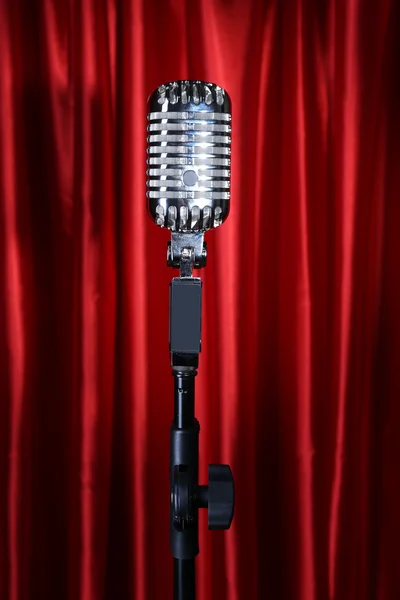 Retro silver microphone on red fabric background — Stock Photo, Image