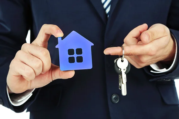 Businessman hands with keys and model of house, closeup — Stock Photo, Image