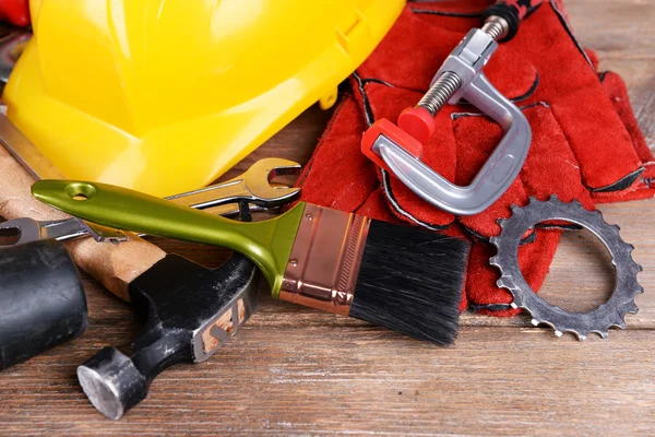 Construction tools with helmet on table close up — Stock Photo, Image