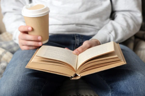 Young man reading book, close-up, on light background — Stock Photo, Image