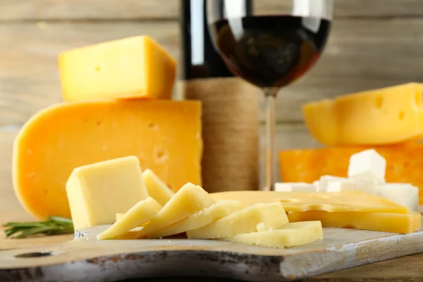 Various types of cheese with wine on table close up — Stock Photo, Image