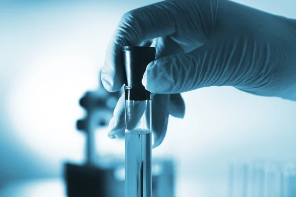 Test tube in scientist hand in laboratory — Stock Photo, Image