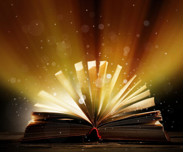 Book with light over dark background