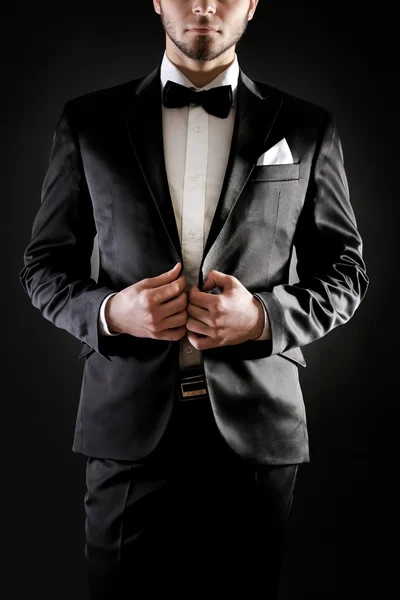 Elegant man in suit on dark background — Stock Photo, Image