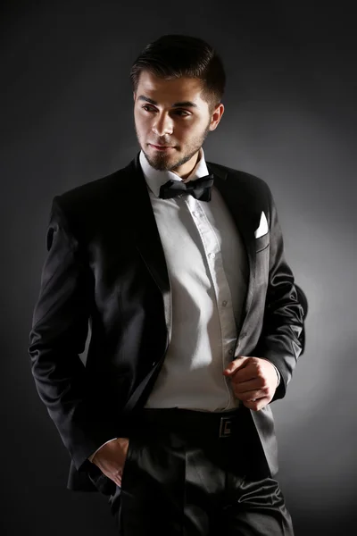 Elegant man in suit on dark background — Stock Photo, Image