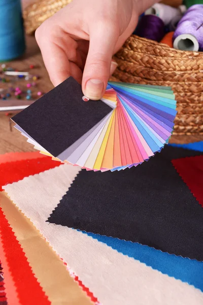 Samples of colorful fabric in female hand, closeup — Stock Photo, Image