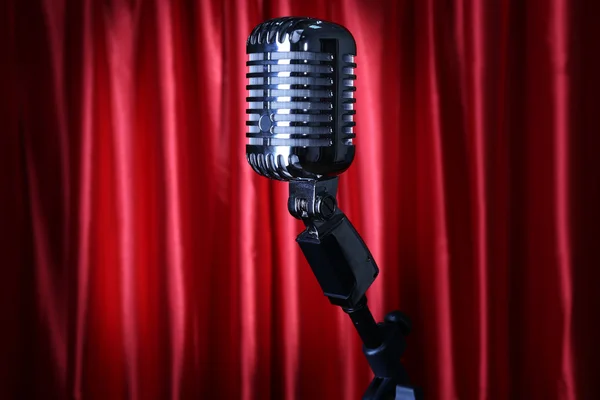 Retro silver microphone on red fabric background — Stock Photo, Image