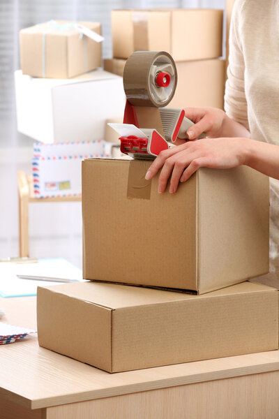 Woman packs parcel in post office