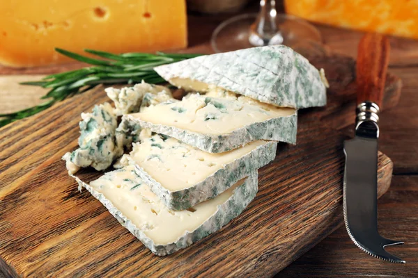 Slices of tasty blue cheese on cutting board close up — Stock Photo, Image