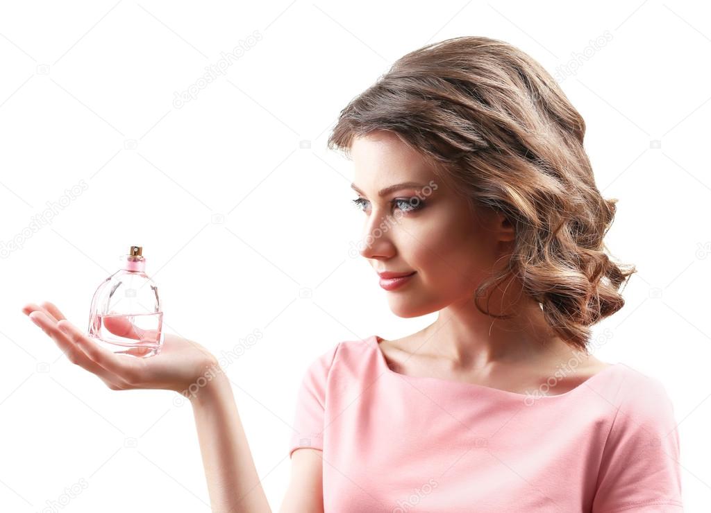 Beautiful woman with perfume bottle isolated on white